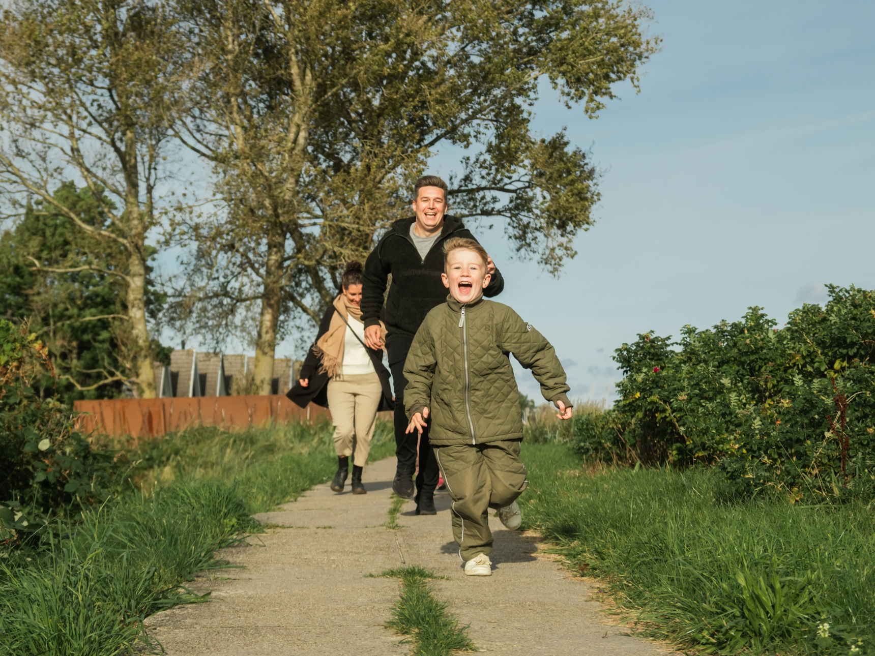 Familie, der løber langs diget ved Hasmark Strandoase